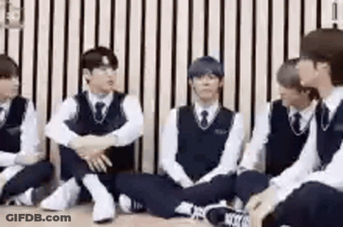 Group Of Young Men Sitting On Floor Against Wall GIF