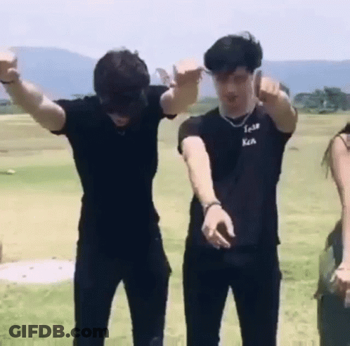 Group Of Young Men Standing In Grassy Field GIF