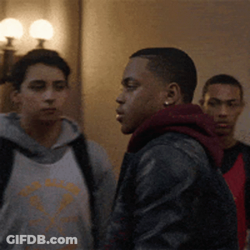 Group Of Young Men Standing In Hallway GIF