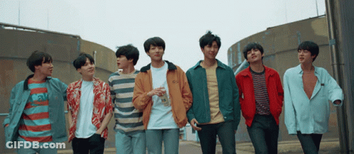 Group Of Young Men Standing On Street GIF