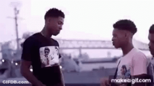 Group Of Young Men Standing On Street GIF