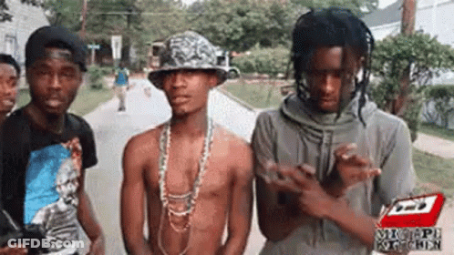 Group Of Young Men Standing On Street GIF