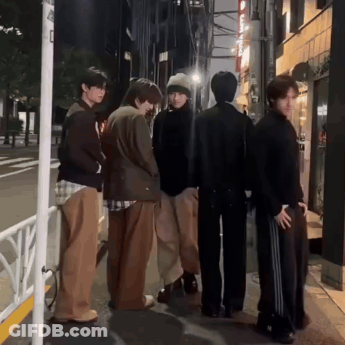 Group Of Young Men Standing On Street GIF