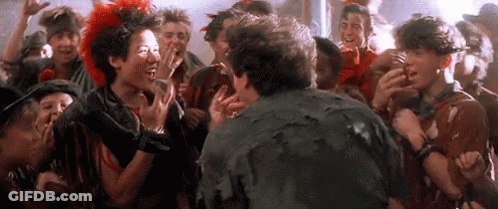 Group Of Young People Standing Around Man In Crowd GIF