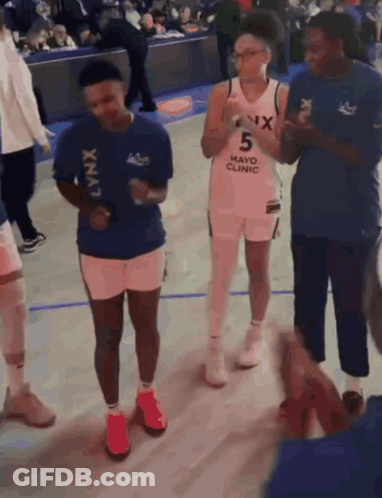 Group On Basketball Court Wearing Mayo Clinic Shirt GIF