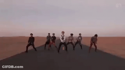 Group On Desert Road Arms Raised GIF