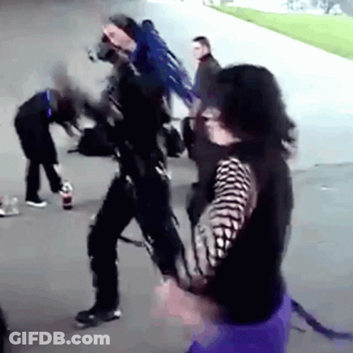 Group On Sidewalk One In Black And White Striped Shirt GIF