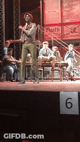 Group On Stage With 6 Sign GIF