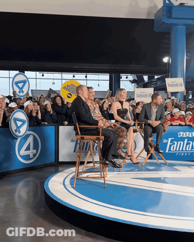 Group On Stage With Fantastic 4 Sign GIF