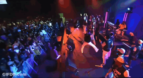 Group On Stage With Fox News Screen GIF