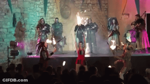 Group On Stage Woman Holding Torch GIF