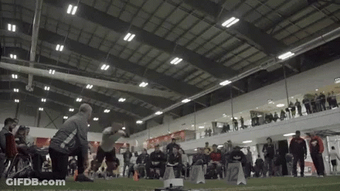 Group Playing Game In Indoor Arena With A Sign GIF