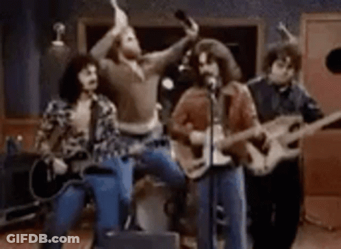 Group Playing Guitars And Singing Into Microphones GIF