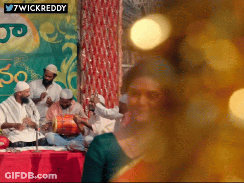 Group Playing Instruments In Front Of 7Wickreddy Sign GIF
