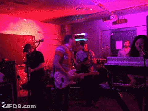 Group Playing Instruments In Front Of Exit Sign GIF