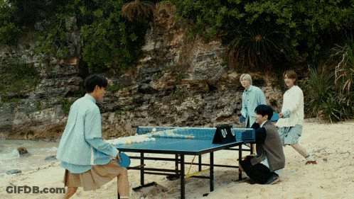 Group Playing Ping Pong On Beach GIF