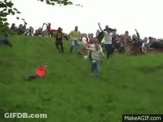 Group Playing Soccer On Grassy Hill GIF
