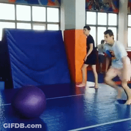 Group Playing Volleyball On Blue Mat In Gym GIF