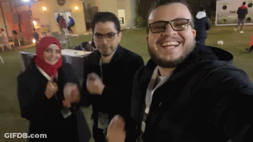 Group Posing For Selfie With Name Tag Saying A GIF