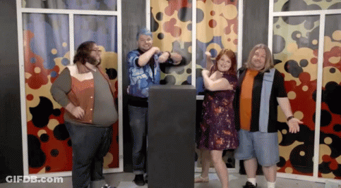 Group Posing In Front Of Colorful Curtain GIF