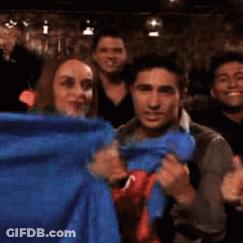 Group Posing With Blue Cloth GIF