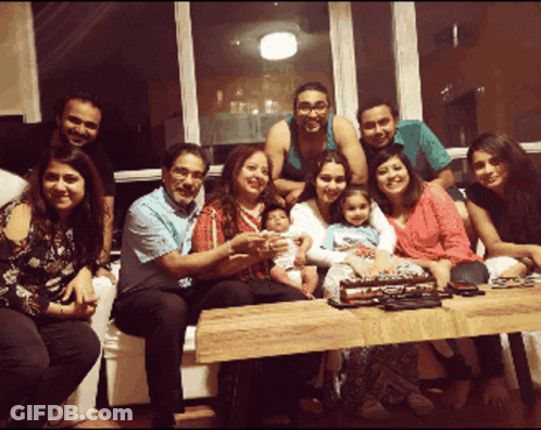Group Posing With Cake GIF