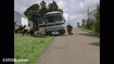 Group Pushing Bus Crashed Into Grassy Hill GIF
