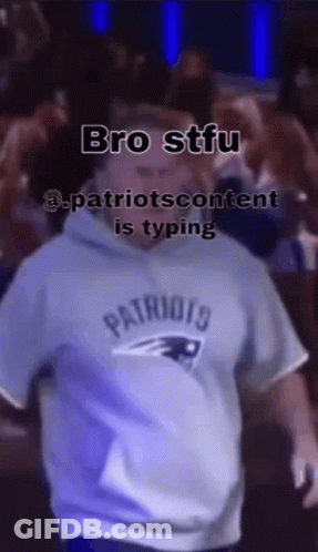 Group Running In Front Of Brick Building With Man On Their Back GIF