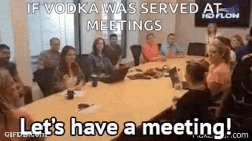 Group Sitting Around Conference Table With Laptop GIF