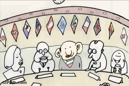 Group Sitting Around Table With Flags GIF