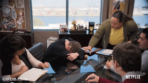 Group Sitting Around Table With Netflix Logo GIF