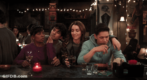 Group Sitting At Bar With Please Sign GIF
