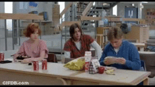 Group Sitting At Cafeteria Table Eating GIF