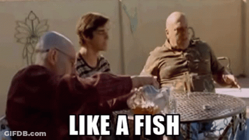 Group Sitting At Table One Holding Beer GIF