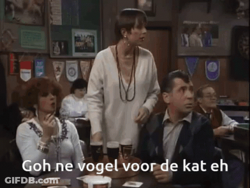 Group Sitting At Table Saying Goh Ne Vogel Voor De Kat Eh GIF