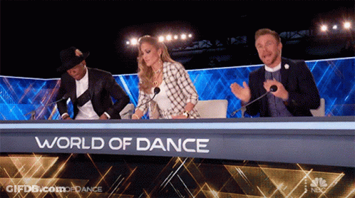 Group Sitting At Table Saying World Of Dance GIF