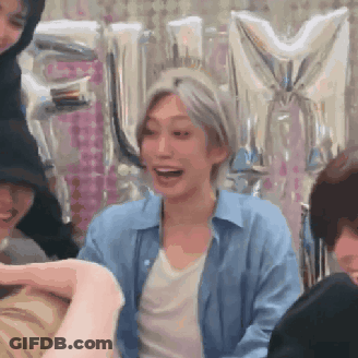 Group Sitting At Table With Balloons GIF