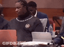 Group Sitting At Table With Laptops And Water GIF