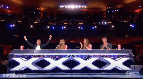 Group Sitting At Table With Large XXX GIF