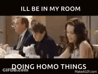 Group Sitting At Table With Man In Suit And Woman In White Dress GIF