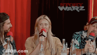Group Sitting At Table With Microphones And Water GIF