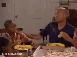 Group Sitting At Table With Pizza GIF