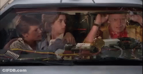 Group Sitting In Car With Clock GIF