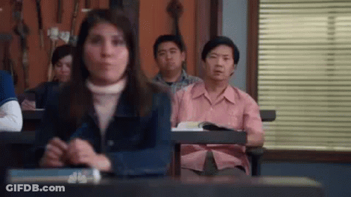 Group Sitting In Classroom With Hands Folded GIF