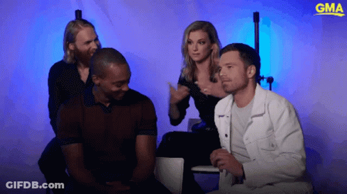 Group Sitting In Front Of Blue Background With GMA Logo GIF