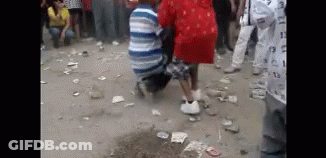 Group Sitting In Front Of Flower-Covered Coffin GIF