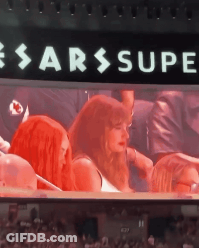 Group Sitting In Front Of Sarssupe Sign GIF