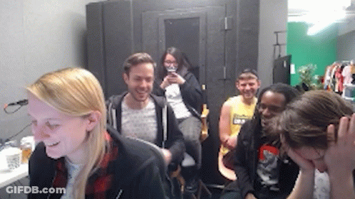 Group Sitting In Room One Holding Head GIF