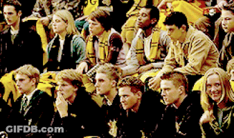 Group Sitting In Row Wearing Scarves With Letter G GIF