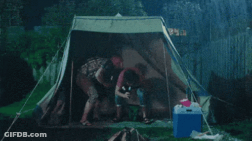 Group Sitting In Tent With Blue Cooler GIF